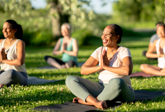 Group of people doing yoga outside