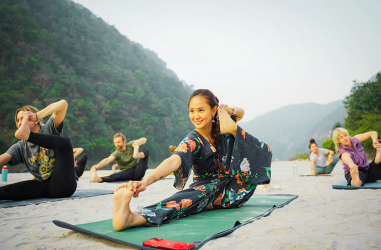people doing yoga outside in the mountains